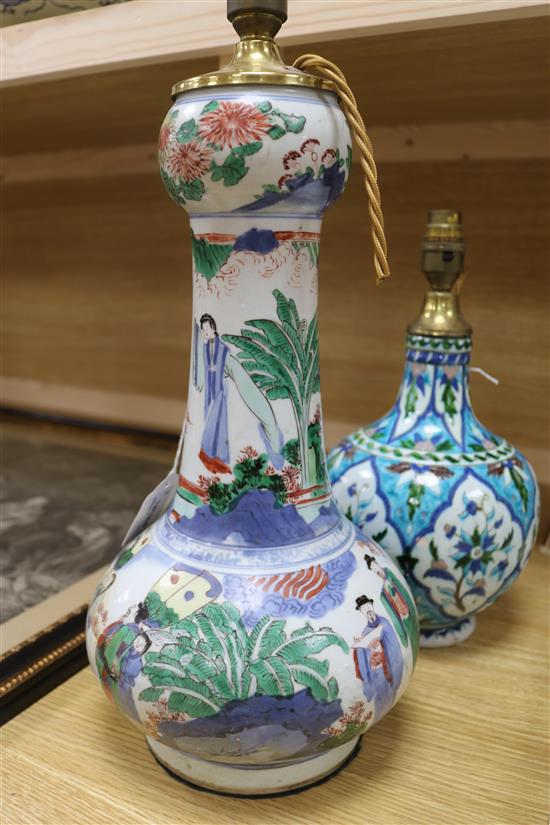 A Chinese wucai garlic-mouthed vase, late 17th century, restored, hole to base and an Isnik style baluster vase, possibly Kutahya (both